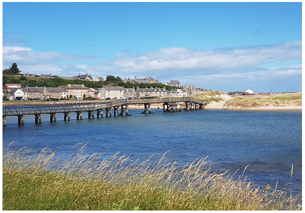 Wooden East Beach Bridge with Lossiemouth  in the background