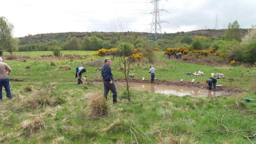 Group carrying out work on riverbank