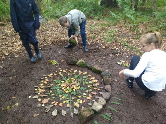 Children building a circle with stones