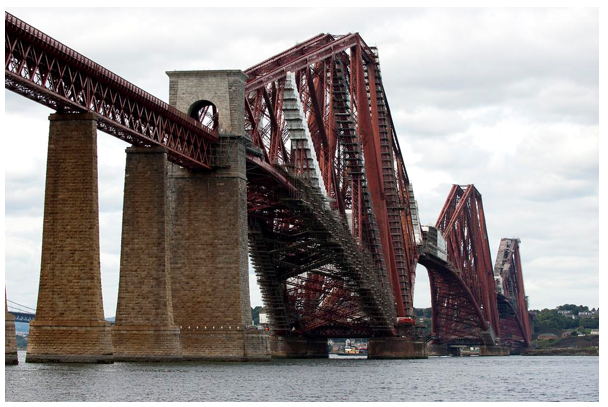  red steel forth rail bridge with brick pillars 