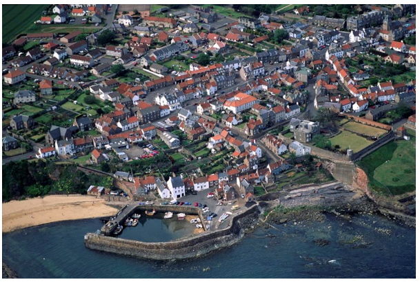 Crail townscape and its harbour with stone wall and a few boats