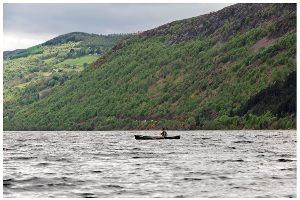 Great Glen Canoe Trail - Canoe in water surrounded by hills