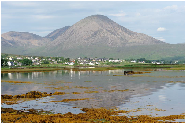 The settlement of Broadford stretched along the shoreline with mainly white houses and Ben Na Caillich behind.