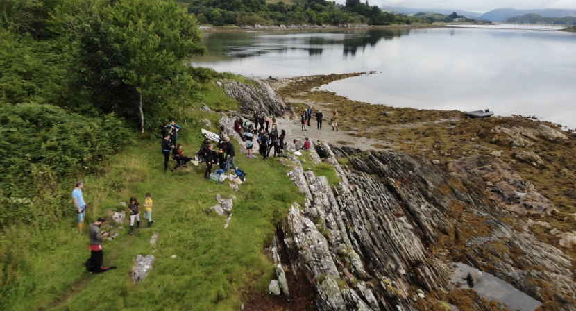 Aerial photograph of volunteers on the rocky shore