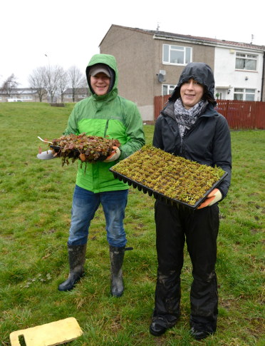 two people gardening outdoors 