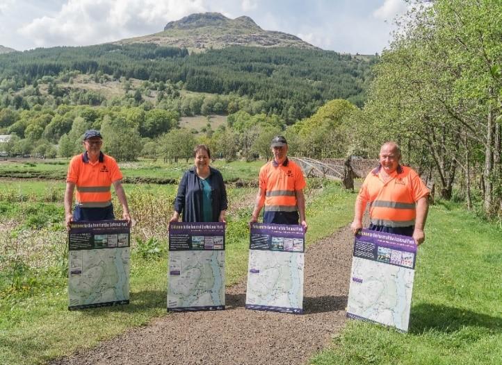 4 staff holding map signs at Arrochar