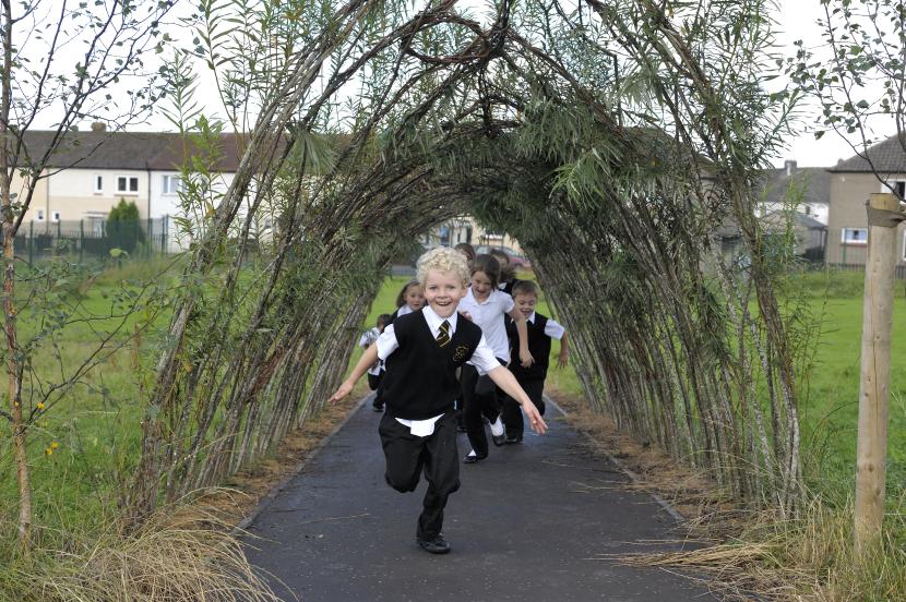 School children playing and exploring within their schoolgrounds