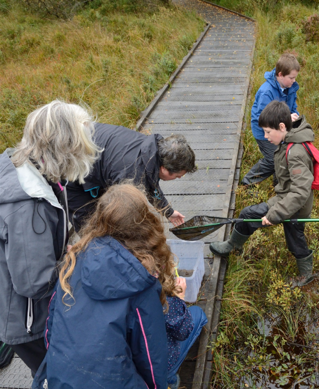  Group of people pond dipping at Taynish National Nature Reserve