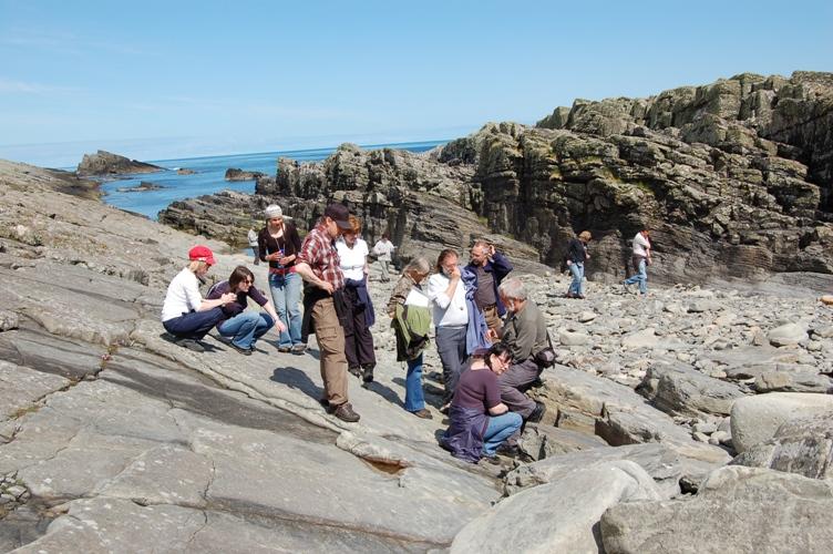 group of people on a tour of Exnaboe fossil locality Shetland
