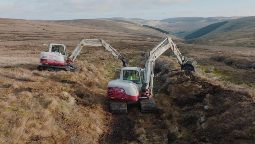 Machine operators reprofiling and revegetating a gully at Wemyss and March Estates a NatureScot Peatland ACTION restoration site.