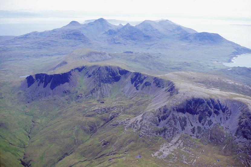 Rounded western hills in the foreground with the peaked Rum Cuillin beyond.