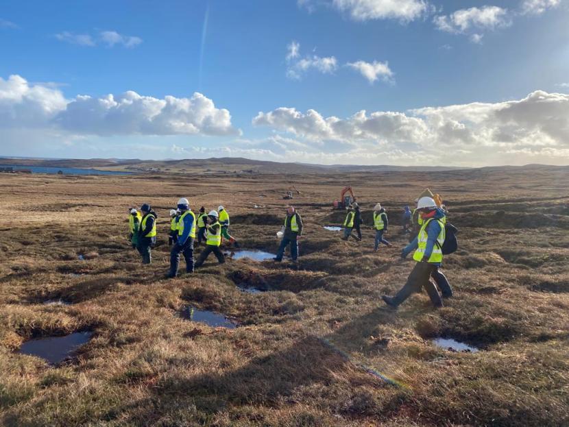 Case study - group of demonstrators walking over peatland at Lochend