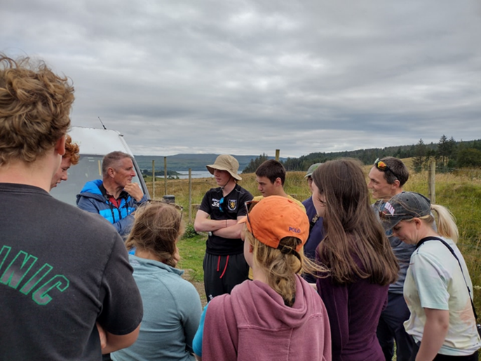 A group of people chatting with a ranger.
