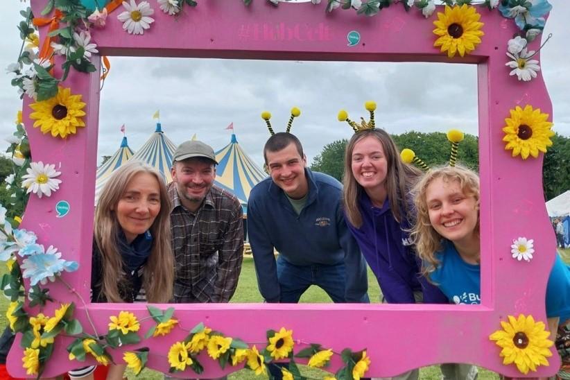 group of people in a large floral frame