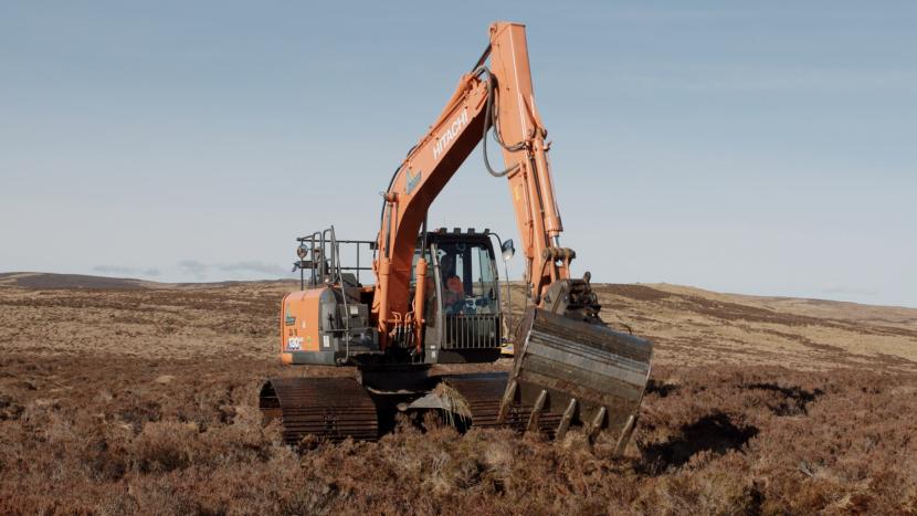 Machine operator blocking a ditch. ©NatureScot Peatland ACTION/Swift Films