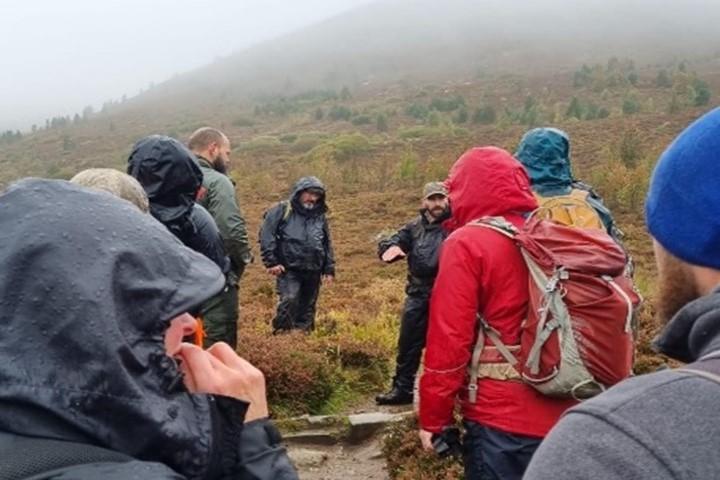 Discussing a water bar with the surfacing eroded away on the downhill side