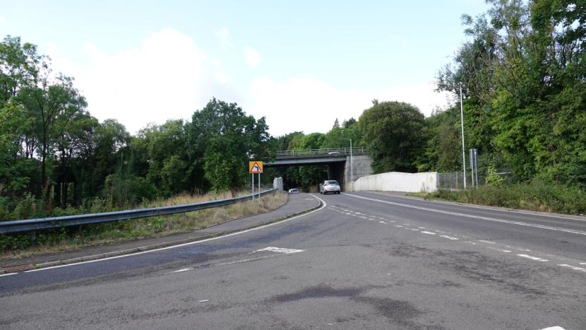 B857 leading through underbridge beneath the A82 trunk road. Also shown is the A82 slip-road junction with the B857, and a crash barrier between it and land parcel 1.