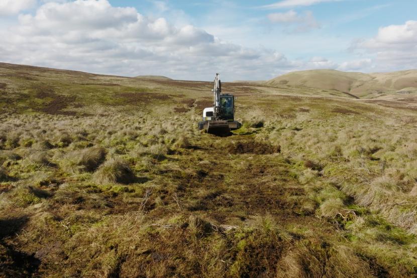 A digger working on a hillside.