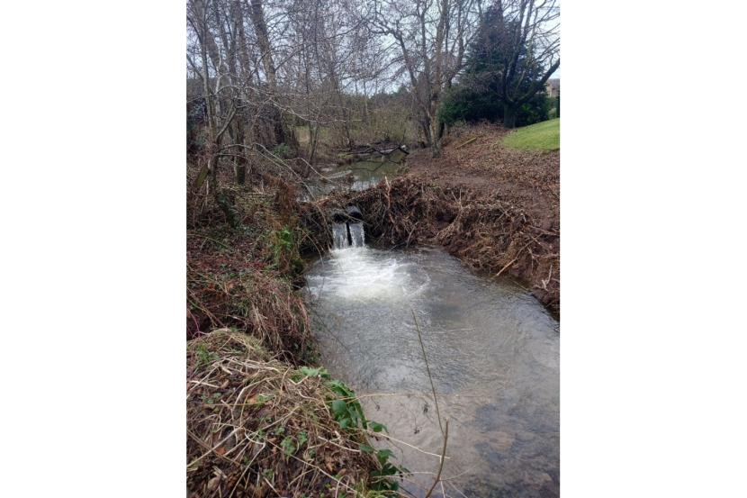 A section of burn with a flow device (piping) installed to help water flow.