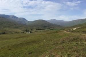 Picture of hilly landscape with blue sky above.
