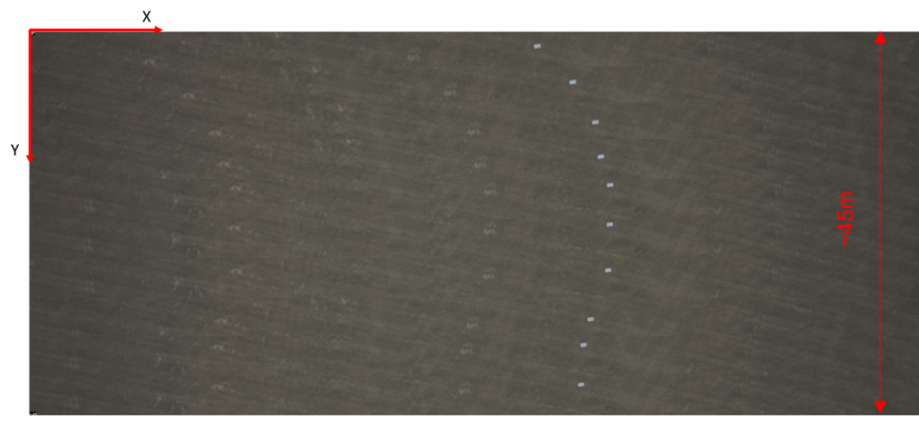 Aerial image of multiple frames recorded over dark land with white rectangular object moving down and curving over the image from frames going top to bottom.