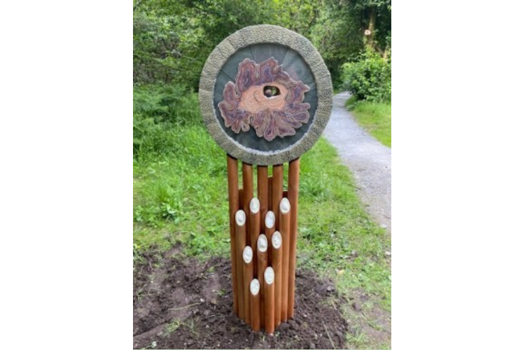 Pauline Muir - Wooden sculpture with large wooden circle on the top.