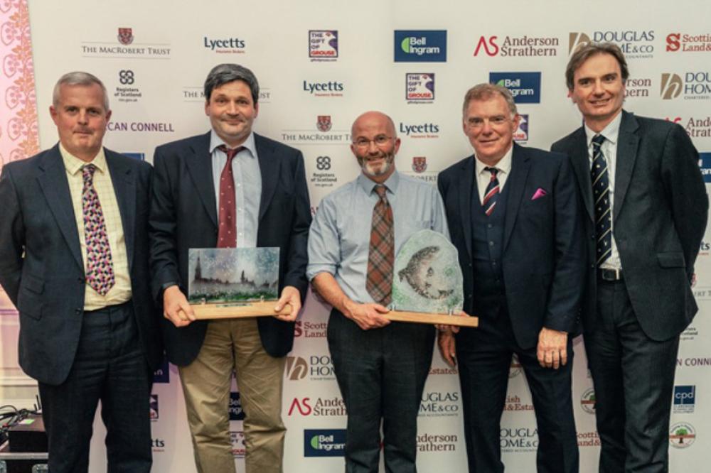 Group photo of Dryhope Farm holding Scottish Land and Estate's Helping it Happen Awards winners trophy for the&nbsp;'Enhancing our Environment' category (2018)