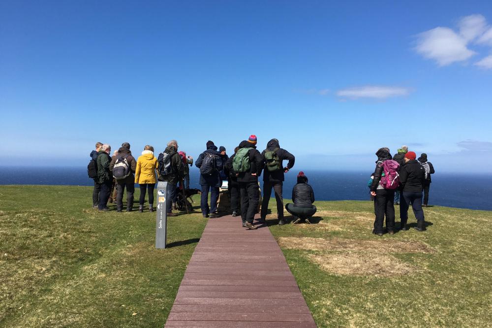 Hermaness Hill Path, a group of people at the interpretation cairn.