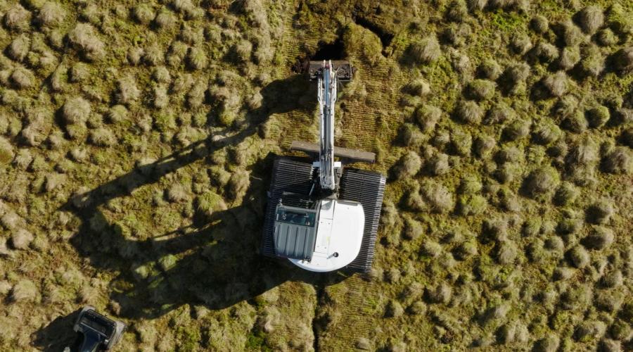 Overhead view of a digger carrying out peatland restoration work 